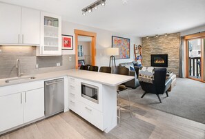 Open living area - Kitchen looking into the living room with beautiful gas fireplace