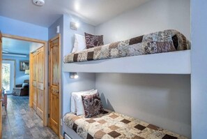 The bunk beds are in between the queen bedroom and the kitchen/living area. Please note, these are small bunk beds twins, so really only good for kids!