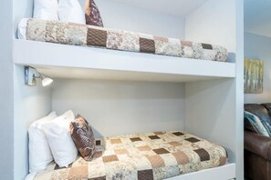 The bunk beds are in between the queen bedroom and the kitchen/living area. Please note, these are small bunk beds so really only good for kids!