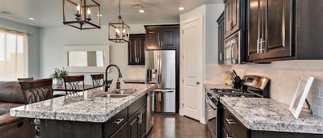 Kitchen Side View - Enjoy preparing meals on our spacious stove and granite counter tops.