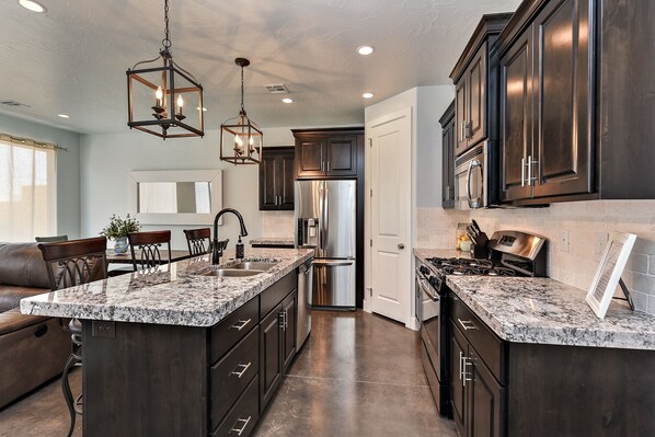 Kitchen Side View - Enjoy preparing meals on our spacious stove and granite counter tops.