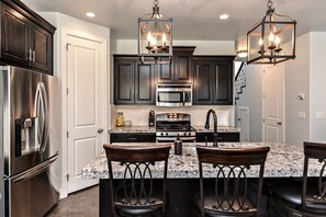 Kitchen - The kitchen is fully stocked with all the dishes, cookware, baking pans, and cutlery you will need for meal preparations and includes stainless steel appliances and granite counter tops.