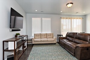 Living Room - The Living Room is located adjacent to the Dining Room and is the perfect place to relax and watch your favorite movie or TV program.