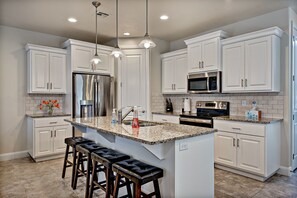 Kitchen - The Kitchen includes stainless steel appliances, granite countertops, walk-in pantry, and plenty of counter space for meal preparations.