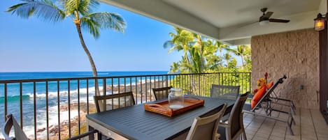 Dining Ocean Front in the lanai of this oceanfront vacation rental, with a table and seating.