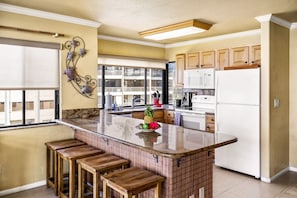 A breakfast bar and the kitchen