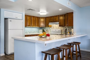 Kitchen with Breakfast Bar, Bar Stools, and Refrigerator