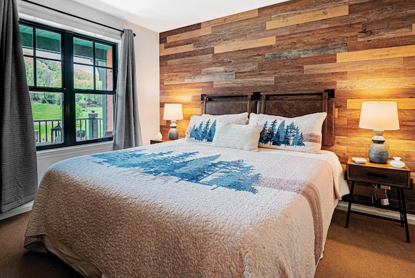 Stunning bedroom with king mattress and NEW faux wood wall with mtn front views