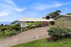 Perched on an 1 & 1/2 acres of lushly landscaped grounds