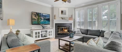 Living area with fireplace and balcony access.