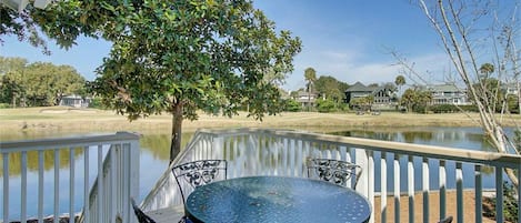 Outdoor dining with golf and lagoon views.