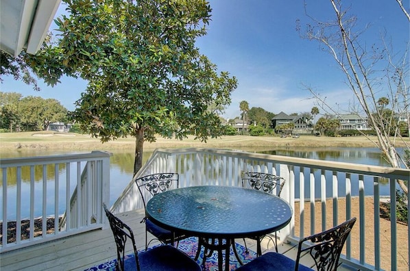 Outdoor dining with golf and lagoon views.