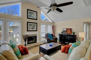 Living area with fireplace and ceiling fans.