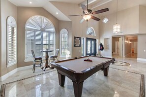 A Pool table for entertaining right as you walk in the home