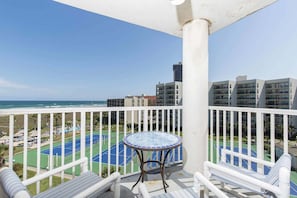 From the balcony, watch the tennis court come alive with activity,