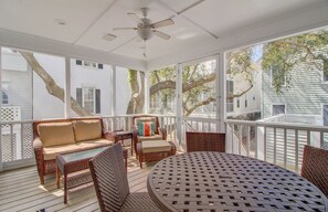 Screened in porch with plenty of seating.