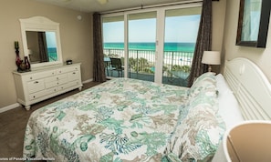 Master bedroom with sliding glass doors leading to the balcony