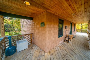 An expansive covered deck leads to the front door of Marble Mountain Chalet.