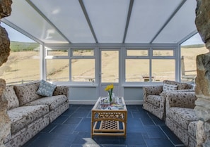 Through the sitting room into the conservatory