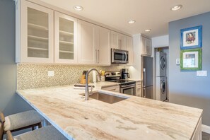 Kitchen with Breakfast Bar, Refrigerator, and Microwave