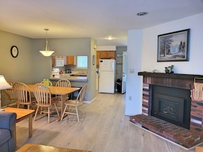 Gas fireplace with view to dining area and kitchen