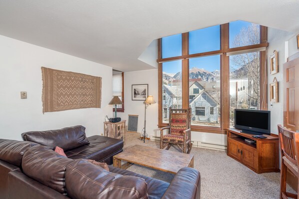 Living room with a flat-screen tv and a leather couch