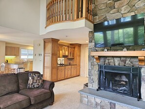 Fireplace, TV and kitchen beyond