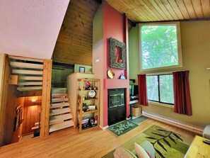Living are with fireplace, TV and stairs