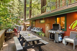 Spacious back deck with outdoor dining and BBQ.