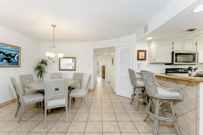 The dining corner is both playful and well appointed with seating for 6 around the table and extra stools at the breakfast bar!