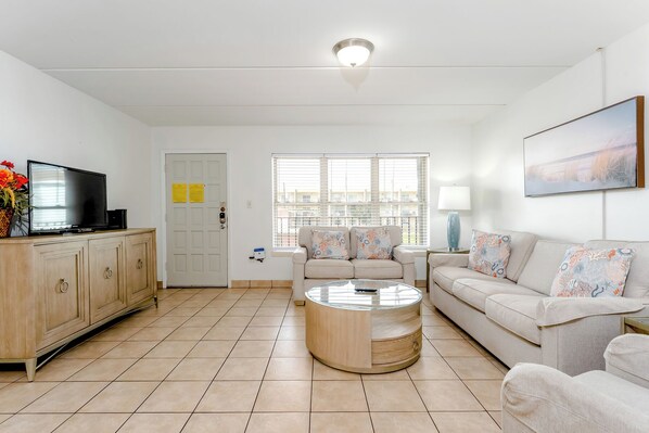 Welcome to your next vacation spot! The living room has nautical touches and bright windows.