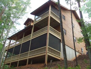From this view you can see the screened porches which provide a nice sitting area on the Master Deck and a great enviroment for your relaxing time in the Hot Tub