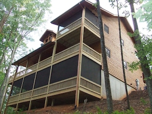 From this view you can see the screened porches which provide a nice sitting area on the Master Deck and a great enviroment for your relaxing time in the Hot Tub