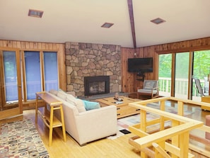Living room with gas fireplace and view to decks