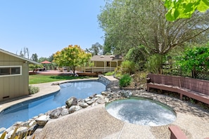 Like an oasis, the hot tub (avail. yearround) overlooks the pool, lawn, and deck.