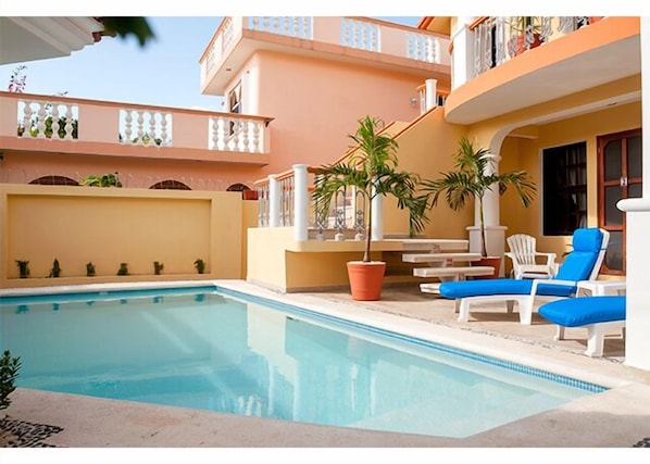 Refreshing pool and loungers right outside your door