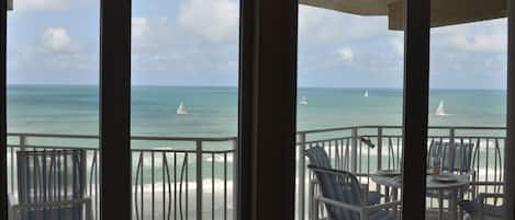 View through the dining room windows of the balcony and ocean (sailboat regatta)
