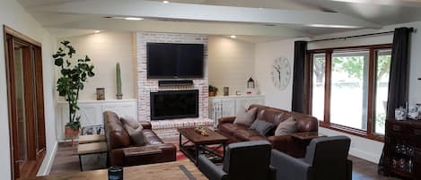 Cozy family room seats 8 comfortably with a very large fireplace and 61 inch TV