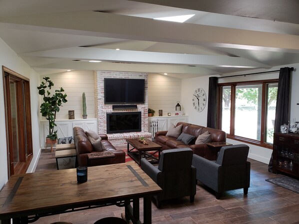 Cozy family room seats 8 comfortably with a very large fireplace and 61 inch TV