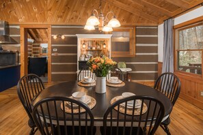 The dining area is well lit with overhead lighting and large windows