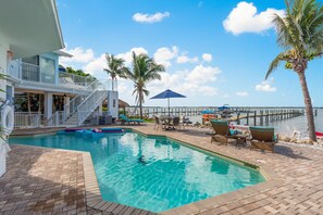 View to the SW, looking over heated pool and private dock. Breathtaking sunsets!