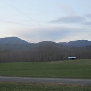 View of Mountains looking across hay fields.