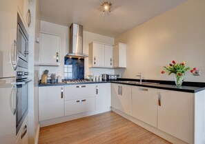 The white high gloss modern kitchen