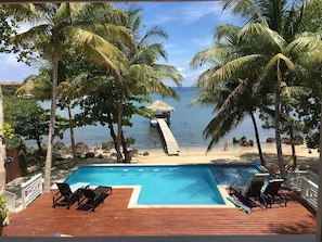 View from the house of the pool, beach and dock.