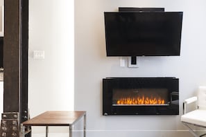 Electronic fireplace and smart TV with cable in the living room