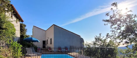 House and garage to the left seen from the end of the pool area