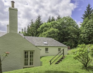 Gardener's Cottage -  side aspect with steps leading up to the lawned garden