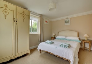 Bedroom with double bed, bedside tables and wardrobe