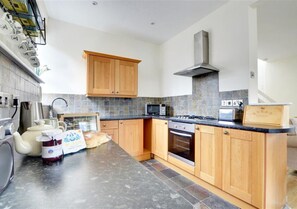The well equipped kitchen area sits to the rear