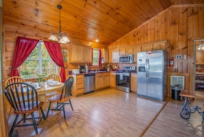 Open concept living space with dining for 4 and full stainless kitchen